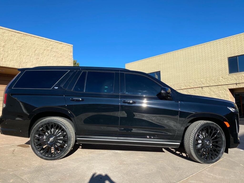 blacked out Cadillac Escalade side view