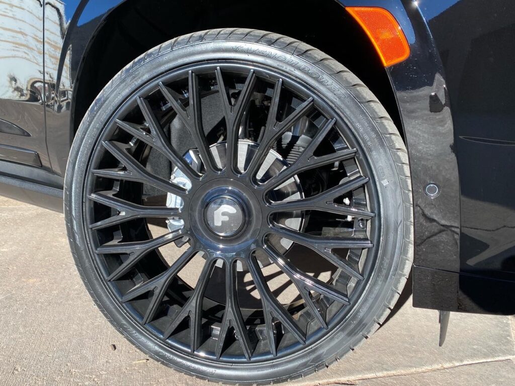 blacked out Cadillac Escalade custom wheels