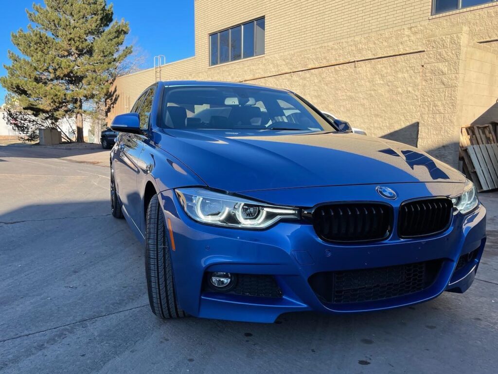 blue BMW 330 outside Mile High Customs